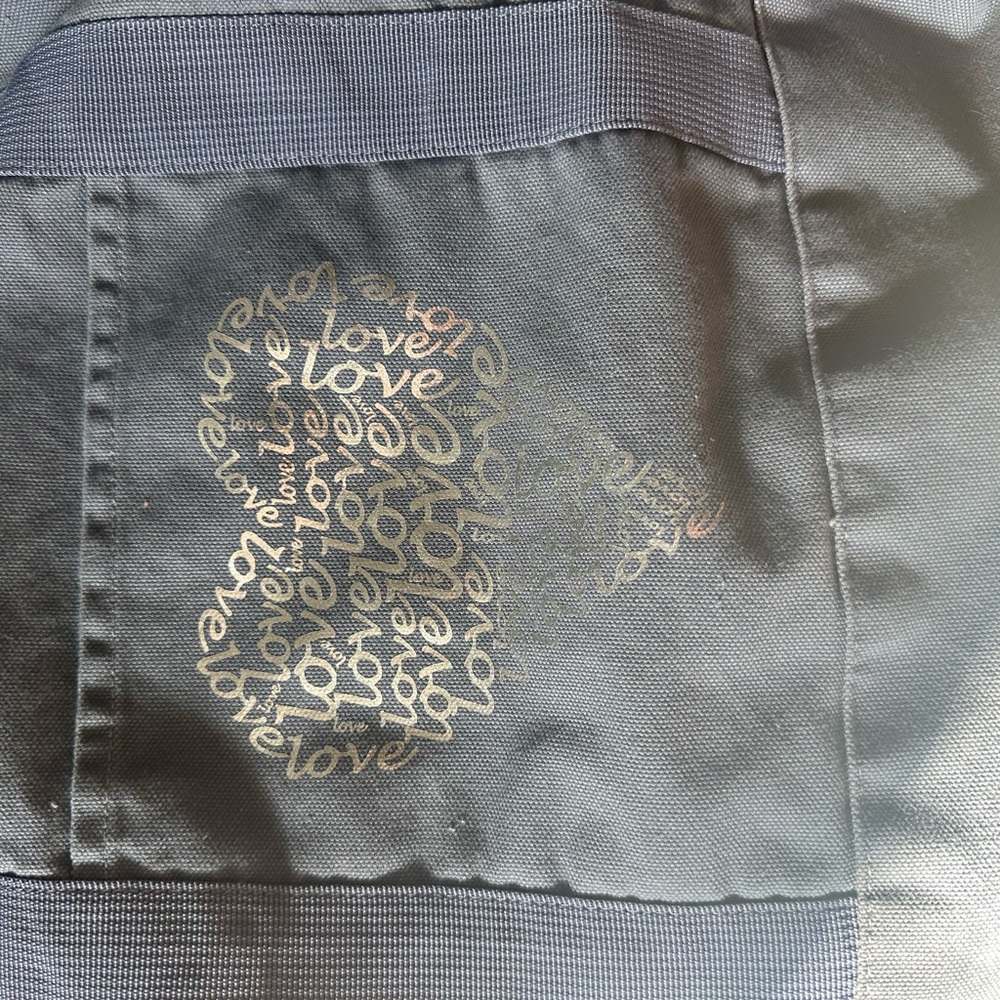 Canvas Tote. Zip pocket inside.  Snap closure.